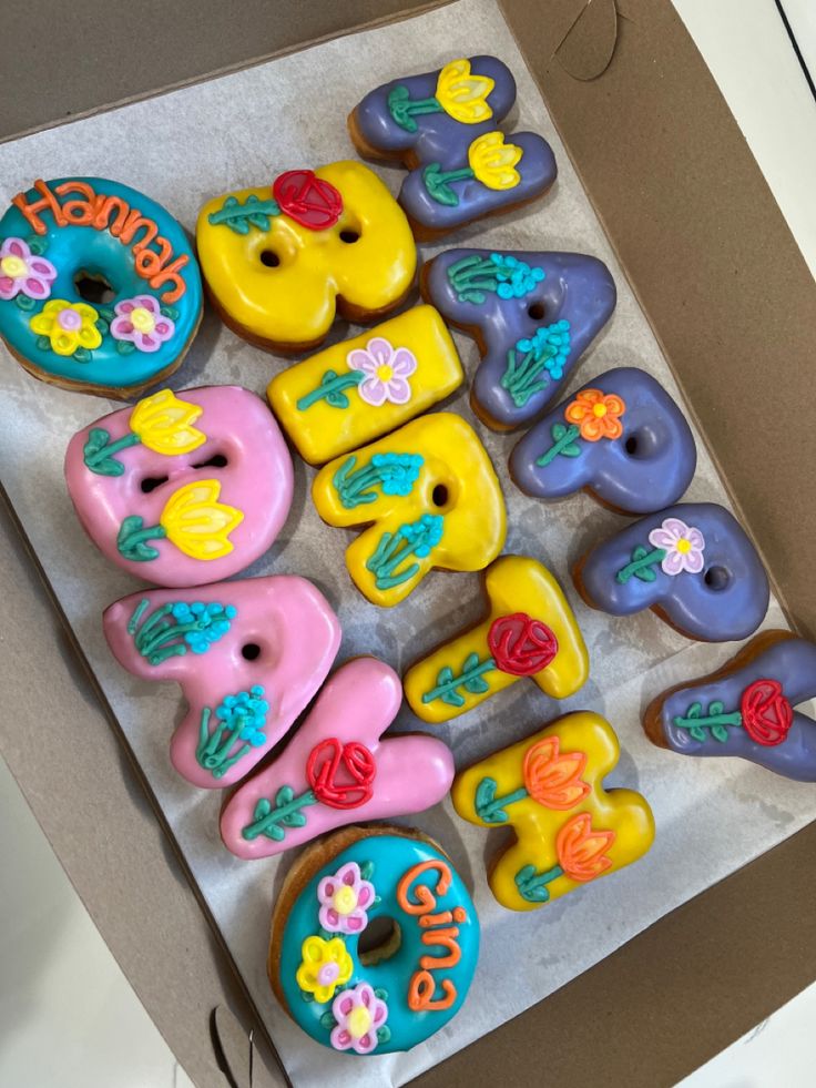 there are many decorated doughnuts in the box