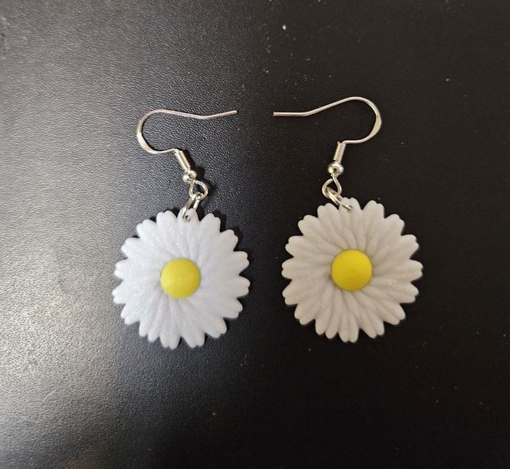 Elevate your style with these exquisite Daisy Earrings, crafted to add a touch of elegance and charm to any outfit. Perfect for both casual and formal occasions, these earrings are a must-have accessory for every fashion-forward individual. White Flower-shaped Trendy Earrings, Trendy White Flower-shaped Earrings, Trendy White Jewelry Set, White Hypoallergenic Dangle Clip-on Earrings, Trendy Handmade Sterling Silver Earrings, Trendy White Drop Earrings, Trendy Nickel Free Flower Shaped Earrings, Pierced Drop Flower Earrings For Everyday, Trendy Everyday Flower Drop Earrings