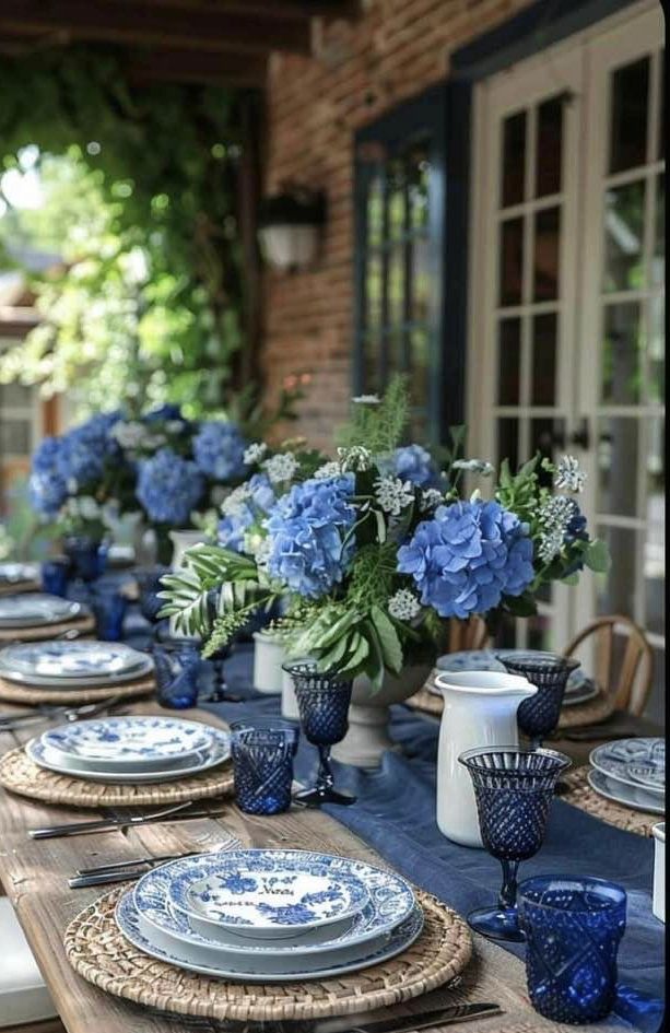 the table is set with blue and white dishes