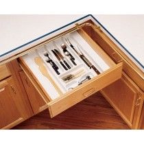 an open drawer with utensils in it