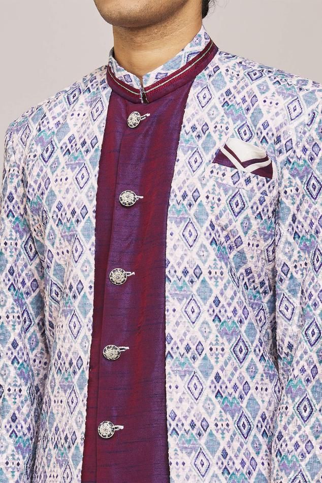 Blue geometric print overlay panel  with purple inner panel sherwani. Comes with churidar.
Components: 2
Pattern: Printed
Type Of Work: Geometric
Neckline: Mandarin Collar
Sleeve Type: Full
Fabric: Sherwani: Rani Digital Jacquard, Silk Dupion,Churidar: Silk Dupion
Color: Blue, Purple
Other Details: 
Embellished buttons
Closure:
Sherwani: Front button
Churidar: Drawstring
Note: Pocket square worn by the model is not for sale
Occasion: Sangeet,Mehendi and Puja - Aza Fashions Blue Sherwani, Embellished Buttons, Churidar, Mandarin Collar, Pocket Square, Aza Fashion, Geometric Print, Sleeve Type, Blue Purple