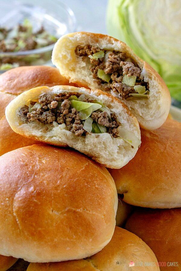 several rolls filled with meat and vegetables sitting on top of each other