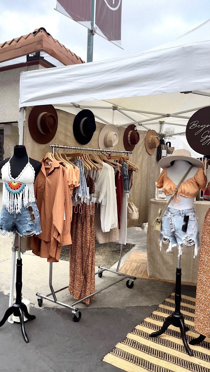 clothes on display under a tent at an outdoor market