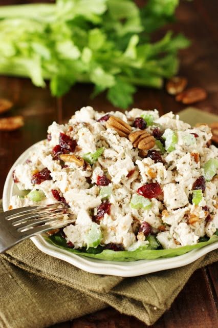 a white plate topped with salad and nuts