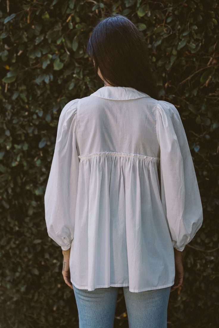 With a sweet Peter Pan collar, our newest blouse is an elevated take on the basic button down—and a layering must-have come cooler weather. Made in a breathable organic cotton, she has pretty puff sleeves and hits at the perfect length for wearing loose or tucked in. Pair her with your fav pants or our new Baye pant in Kara Thoms, Cooler Weather, Pan Collar, Peter Pan Collar, Peter Pan, Puff Sleeves, Puff Sleeve, Sewing Patterns, Layering