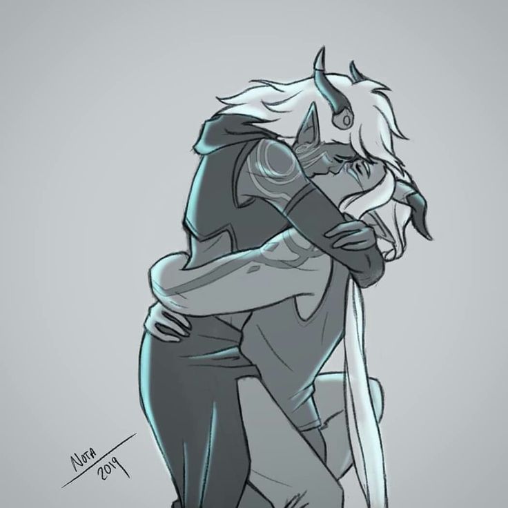 two people hugging each other with one holding the other's head in his arms