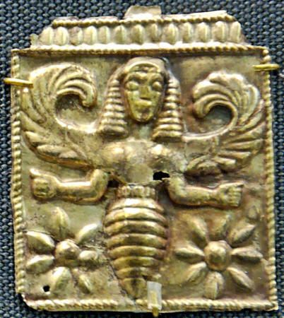 an ancient gold plaque with two faces