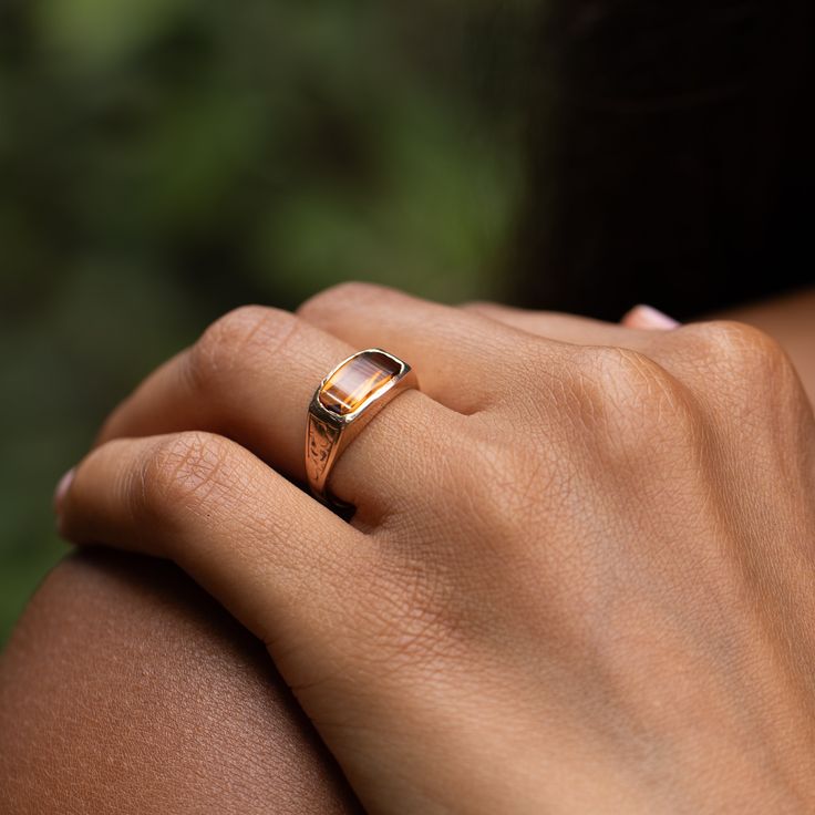 The Story A chic and classic Victorian era ring set with a beautiful citrine sitting front and center. Constructed from 14k rose gold, the long faceted stone measures 12.2 mm by 6.3 mm. Set flush with the setting, the pieces has a sleek, uniform look and feel. The back is open allowing light to pour through, making the stones color pop. Beautiful hand enraged floral detailing finishes the ring perfectly. The simple, yet classic construction is all this ring needs. We love it worn on its own, paired with other pieces, or stacked with your favorite rings. The Specs Style Number: R3536 Victorian, 1890s-1900 14 karat rose gold Citrine measures 12.2 x 6.3 mm Height of front face of ring 0.37", depth of ring as it sits off finger 0.13", width of entire ring 0.76" Band width tapers from 3.7 mm do Classic Rose Gold Topaz Ring For Formal Occasions, Classic Rose Gold Topaz Ring For Formal Events, Luxury Rose Gold Topaz Promise Ring, Classic Rose Gold Topaz Ring, Elegant Faceted Citrine Rings, Elegant Amber Birthstone Ring, Elegant Citrine Signet Ring With Gemstone, Rose Gold 14k Gemstone Signet Ring, Elegant Citrine Gemstone Signet Ring