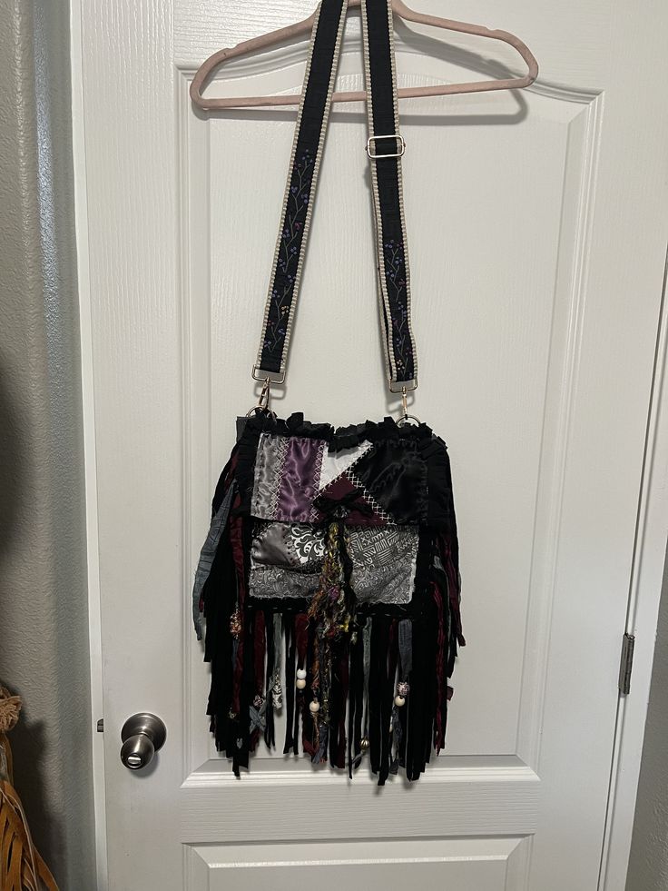 Black/gray/lavender hippie/boho bag/purse with embroidered adjustable guitar strap. Handmade Purple Bags For Festival, Hippie Handmade Festival Shoulder Bag, Hippie Handmade Shoulder Bag For Festival, Handmade Hippie Shoulder Bag For Festival, Black Bohemian Hobo Bag, Bohemian Hobo Bag With Detachable Strap, Bohemian Crossbody Satchel With Fringe, Bohemian Hobo Bag With Detachable Strap For Travel, Black Bohemian Satchel Bag