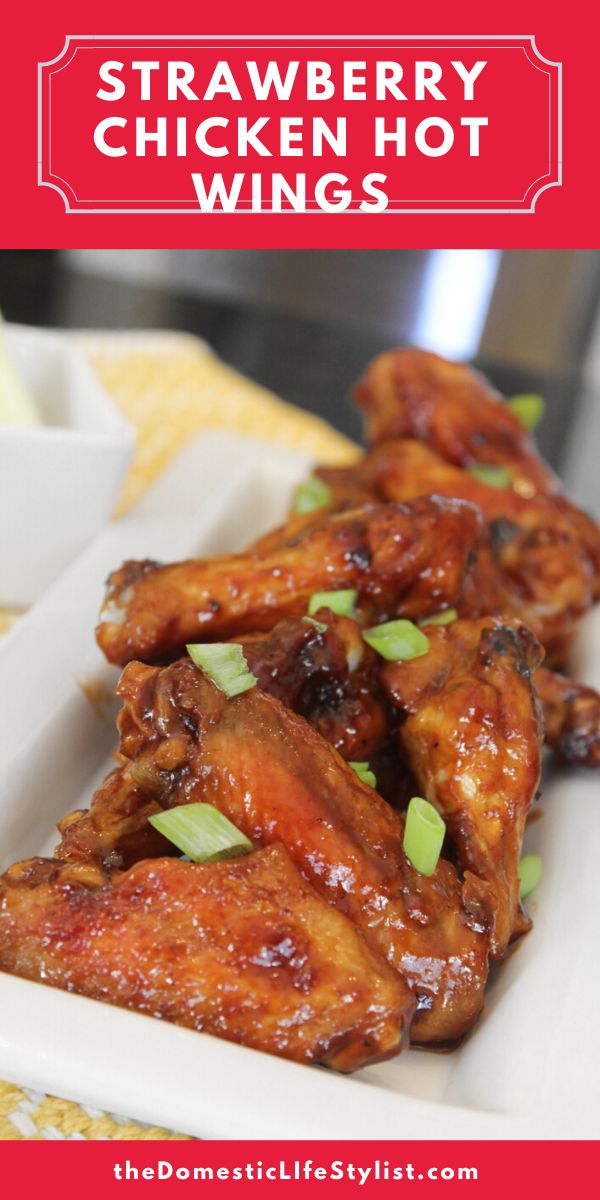 some chicken wings on a white plate with text overlay that says strawberry chicken wings