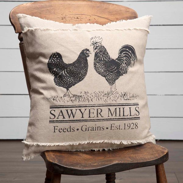 an old chair with a pillow on it that says savyer mills feeds grains