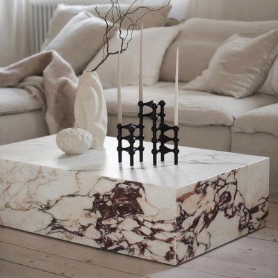 a marble coffee table with candles on it