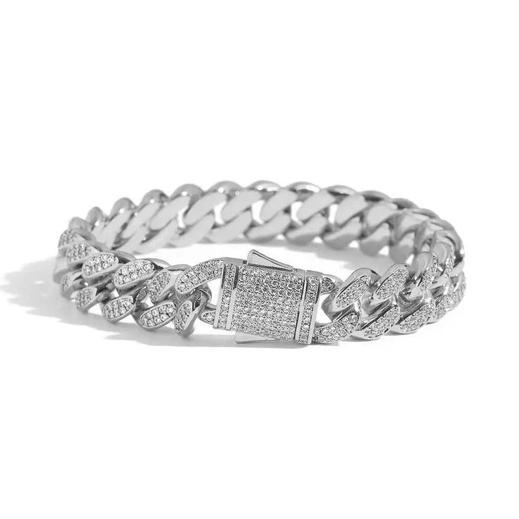 The 12mm Paved Cuban Link Bracelet is fully encrusted with clear stones all the way to the box clasp. PVD Plated guarantees a long-lasting finish. Classic Silver Chain Bracelet With Pave Setting, Classic Silver Bracelets With Pave Setting, Classic Silver Bracelet With Pave Setting, Silver Chain Bracelet With Pave Setting As Gift, Silver Pave Setting Chain Bracelet As Gift, Luxury Silver Chain Bracelet With Sparkling Stones, Elegant Cuban Link Chain Bracelet With Bling, Bling Diamond Bracelets For Formal Occasions, Luxury Diamond White Bracelets With Bling