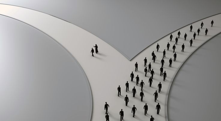 a group of people walking across a white circular structure with an arrow in the middle