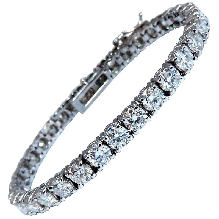 Classic Tennis 11.45ct. Natural diamonds bracelet. Round, full cuts H color Si-2 clarity. 14kt. white gold 13.6 Grams. Width of bracelet: 4.6mm 7 inch wearable length safety clasp/ snap lock $48,000 Appraisal Certificate will accompany. White Platinum Bracelet With Brilliant Cut, White Platinum Tennis Bracelet With 17 Jewels, Formal White Platinum Tennis Bracelet, Silver Brilliant Cut Tennis Bracelet For Formal Occasions, Formal Silver Tennis Bracelet With Brilliant Cut, Luxury Silver Diamond Cut Tennis Bracelet, Formal Silver Diamond Bracelet With Brilliant Cut, Dazzling White Platinum Tennis Bracelet, Luxury Silver Round Cut Tennis Bracelet