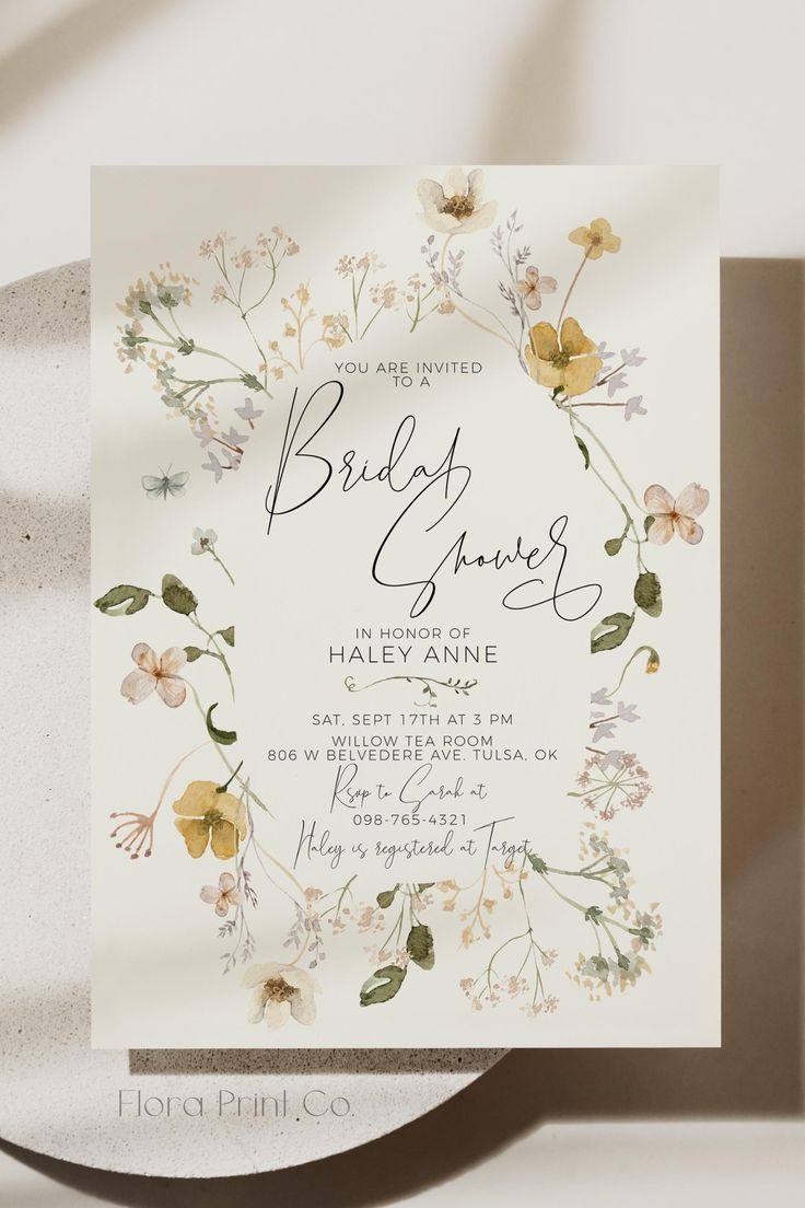 a wedding card with flowers and leaves on it