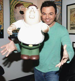 a man standing next to a cartoon character holding his hands out in front of him