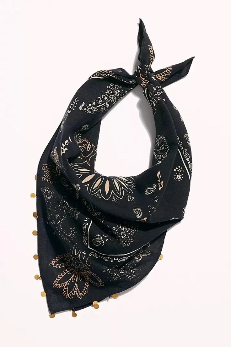 a black and gold scarf with pom poms on the bottom is shown in front of a white background