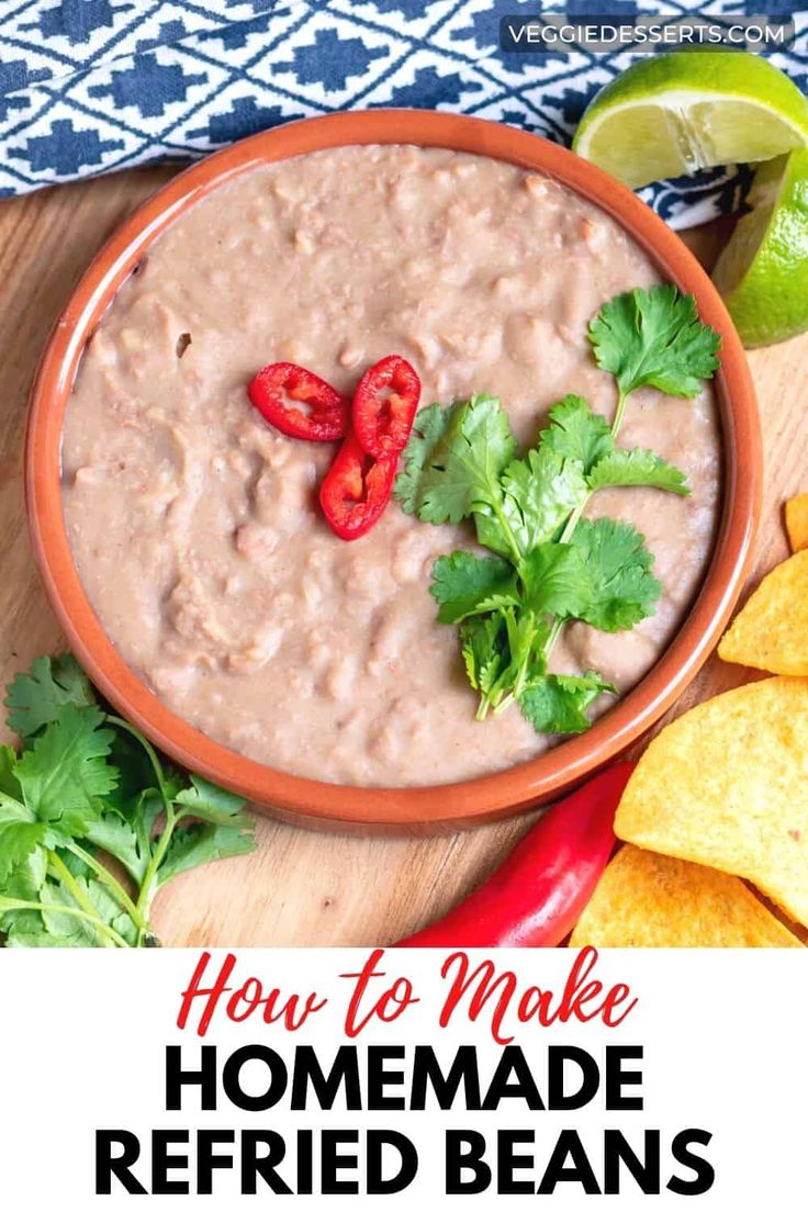 a bowl of homemade refried beans with cilantro and limes on the side