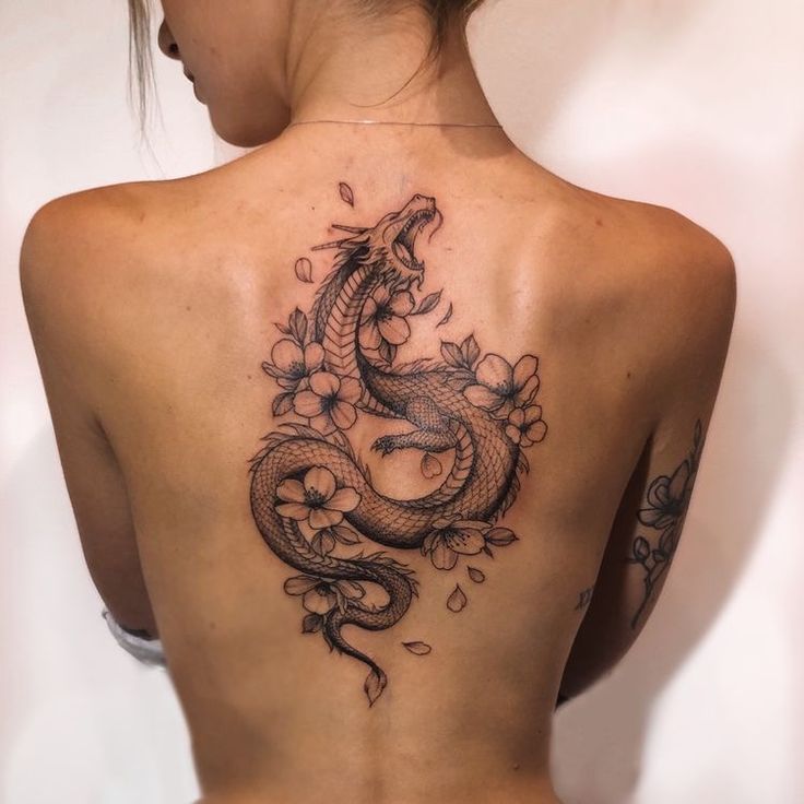 a woman with a dragon tattoo on her back