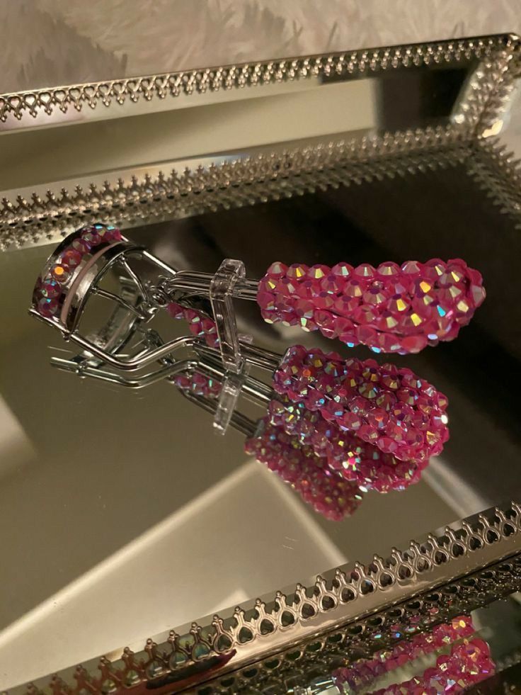 a mirror that has some pink beads on it