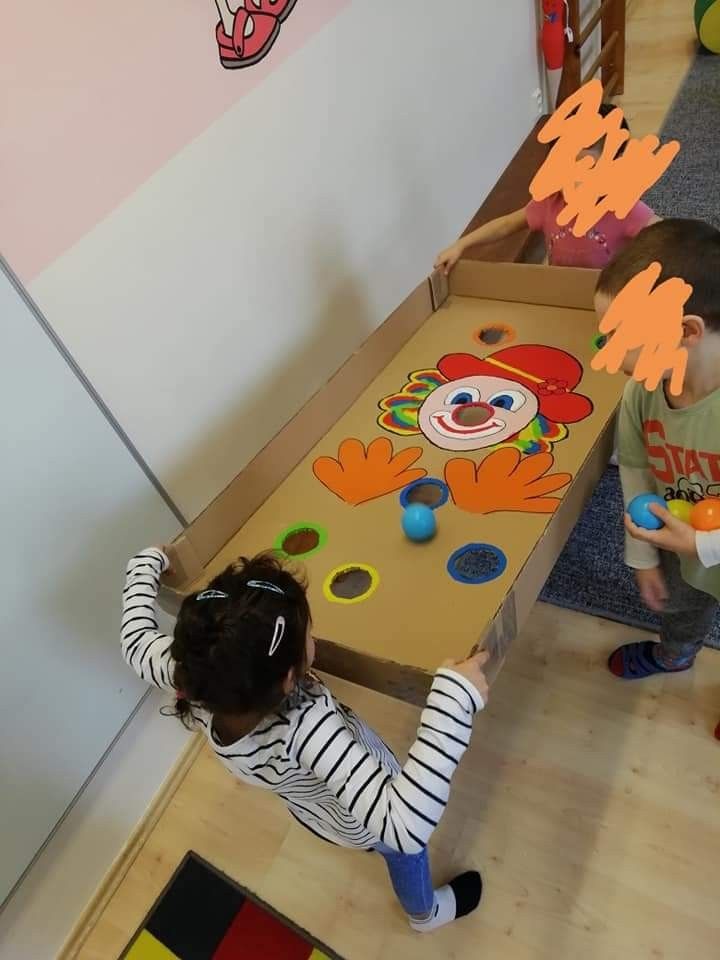 two children playing with toys in a play room