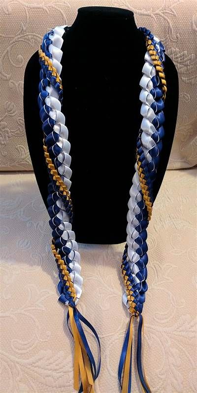 a black mannequin with blue, white and gold braided necklaces on it