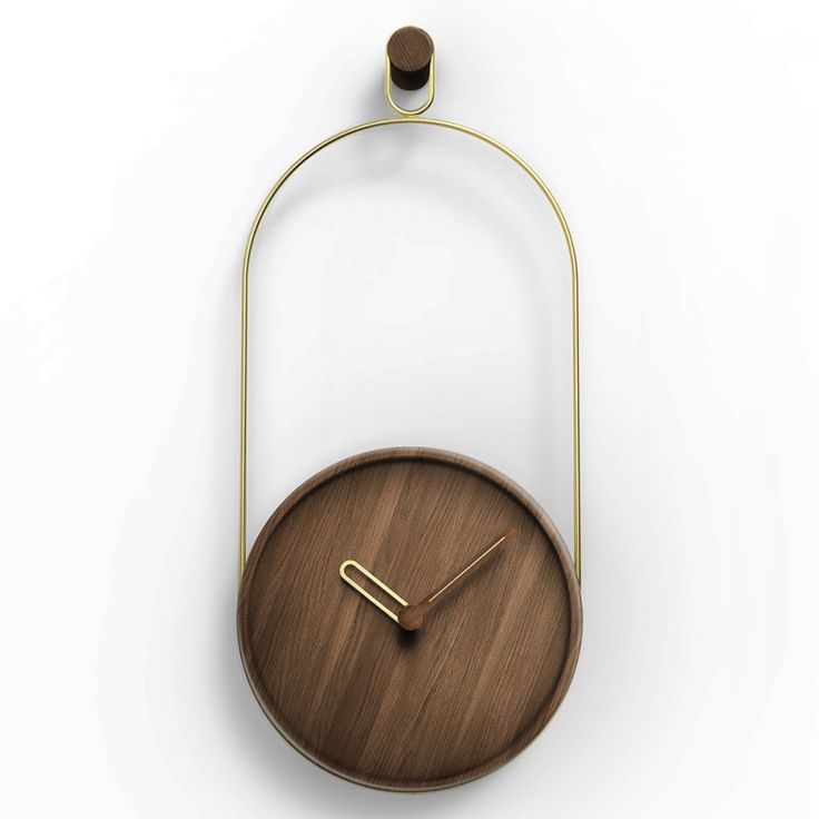 a wooden clock hanging from the side of a white wall with a metal frame around it