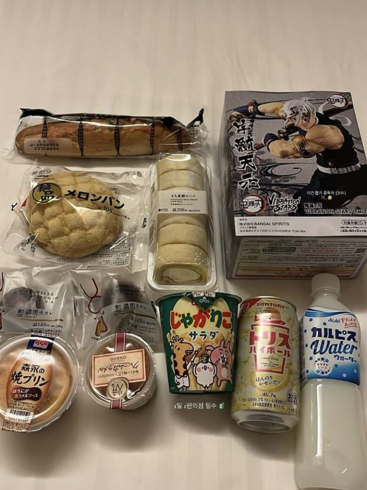 an assortment of food items are laid out on a table top, including bread, milk, and other condiments