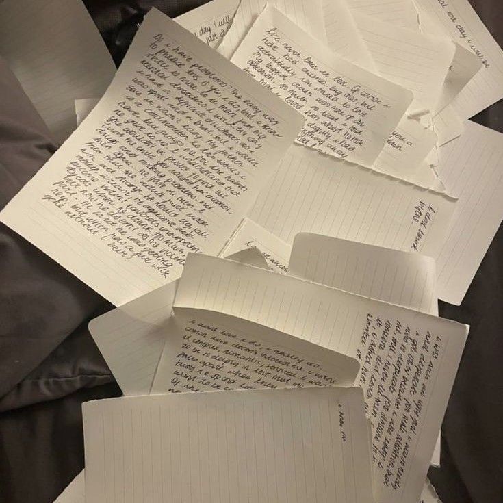 several pieces of paper with writing on them are piled up next to eachother