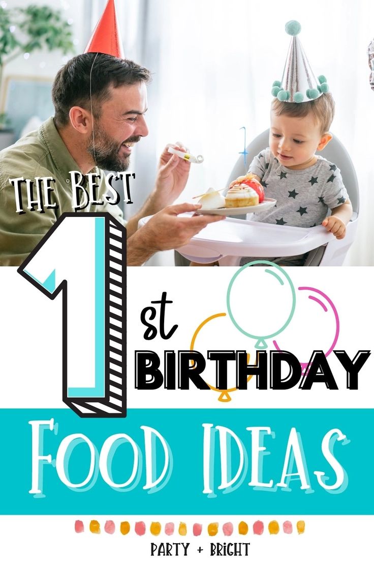 a man holding a baby in front of a birthday sign