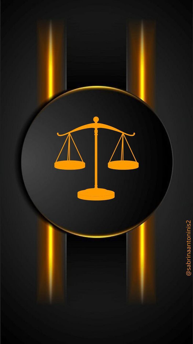 the scales of justice symbol on a black and gold background with lights in the dark