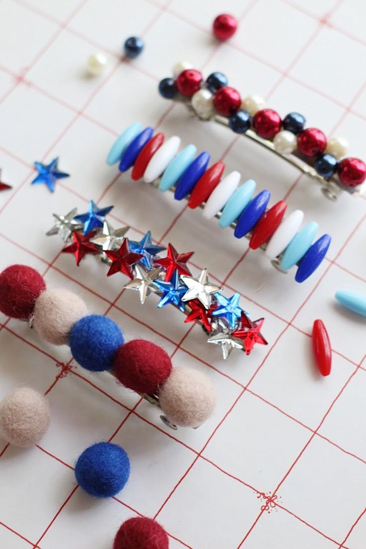 several patriotic pins are arranged on a gridboard with red, white and blue pins