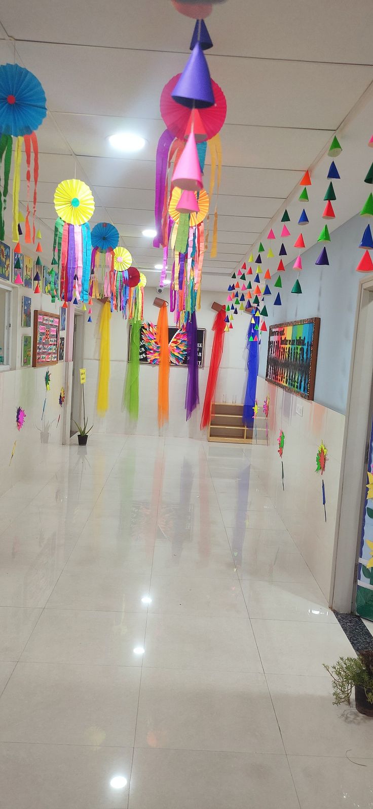 the hallway is decorated with colorful streamers and paper umbrellas hanging from the ceiling