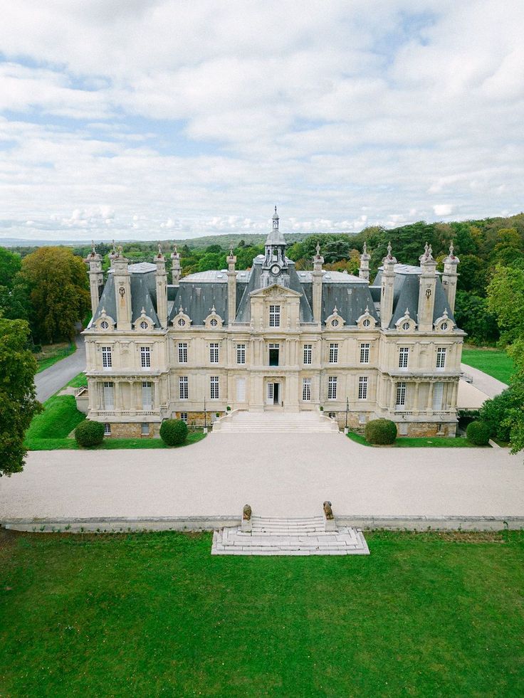 an aerial view of a large mansion in the countryside