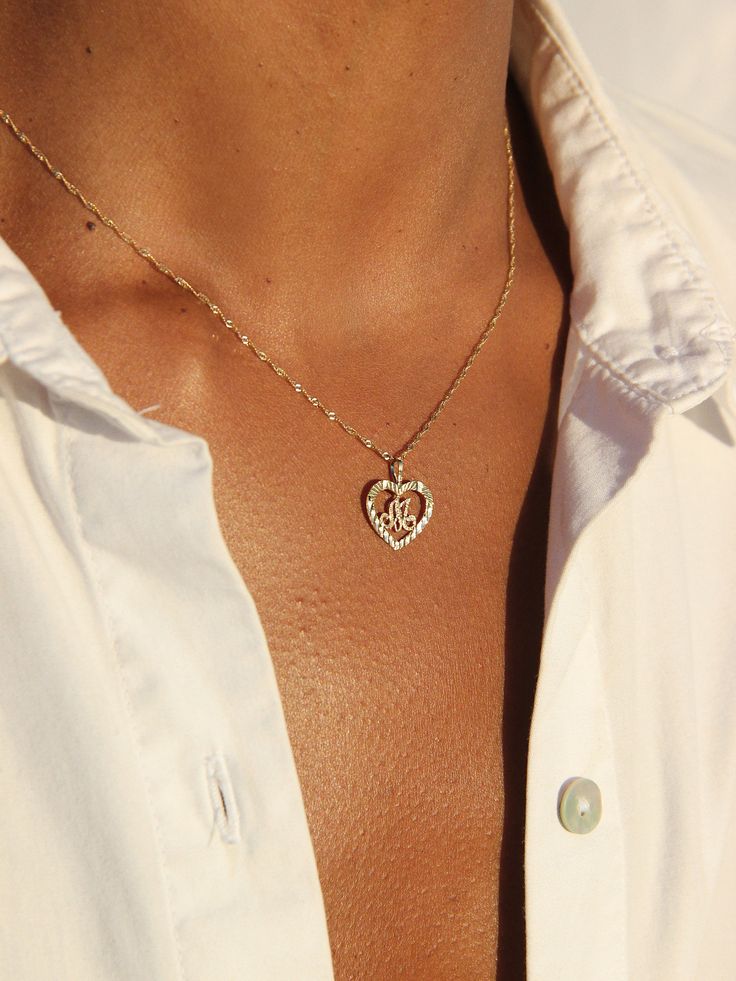 DESCRIPTION Rep yourself or your lovaaah with a sweet, heart-shaped initial necklace. Placed on our Singapore chain for extra shine. DETAILS - always made in 14k gold- pendant measurement: 10mm x 15mm- model wears a 16" in second photo and a 16", 18" and 20" in fourth photo Silver Heart-shaped 14k Gold Name Necklace, Dainty Heart Charm Name Necklace For Anniversary, Rose Gold Heart Pendant Name Necklace, Heart Pendant Name Necklace For Anniversary, Anniversary Necklace With Heart Charm And Initial Pendant, Dainty Anniversary Name Necklace With Heart Charm, Classic Heart Pendant Necklace With Initials, 14k Gold Engraved Heart Name Necklace, Personalized 14k Gold Heart Pendant Necklace