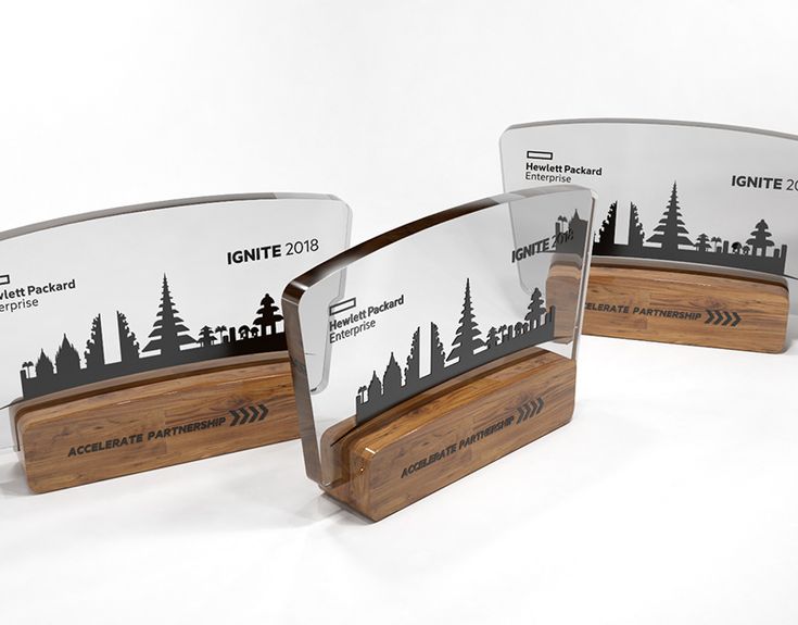 three award plaques with trees on them sitting next to each other in front of a white background