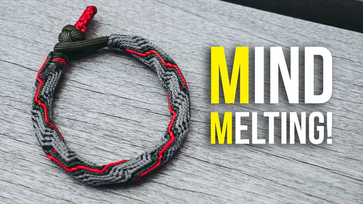 a gray and red bracelet with the words mind melting on it, sitting on top of a wooden table