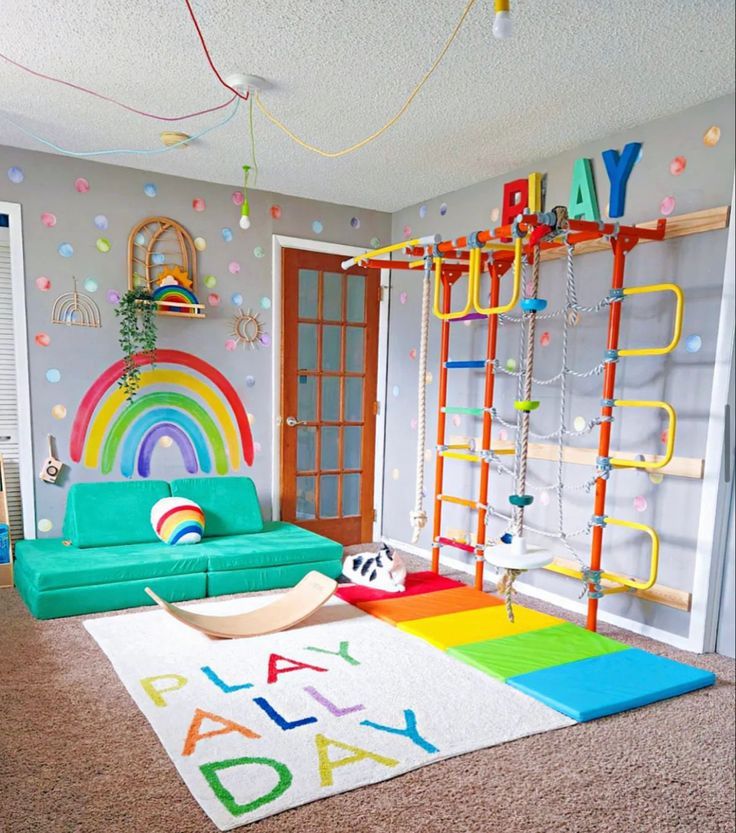 a child's playroom with rainbow rugs, ladders and toys on the floor