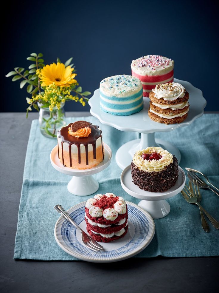 a table topped with cakes and desserts on top of plates