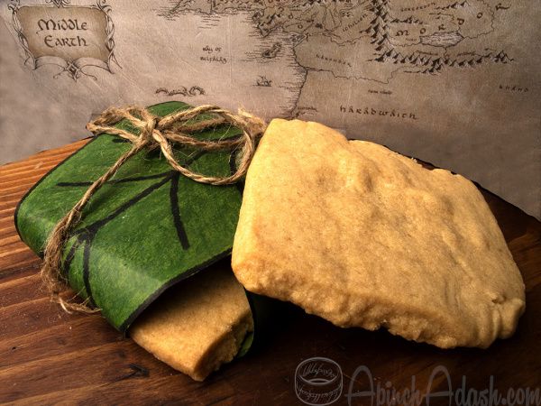 two pieces of bread sitting on top of a wooden cutting board next to a map