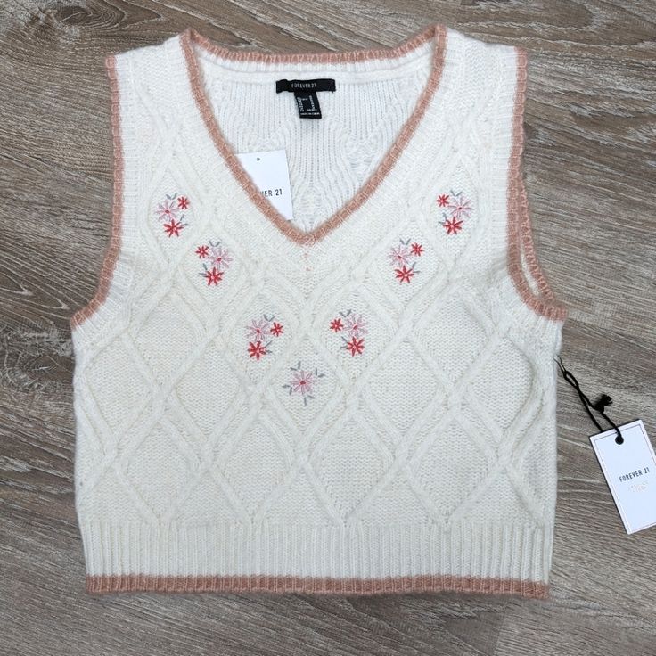 This Is A Super Cute Cream Colored Cropped Sweater Vest With A Light Pink/Beige Trim. Embroidered Florals Under The V-Neck. 8% Wool Blend. From The Forever 21 Premium Collection. Size Medium. Brand New With Tags! From Shoulder To Bottom Of Vest Is 19 Inches Tags Eclectic Grandpa, Lagenlook, Floral, Girly, Sweater Vest, Coastal Grandma, Boho, Prairie, Feminine, Neutral, Embroidered V-neck Top With Floral Embroidery For Winter, Knit Tops With Floral Embroidery For Fall, Floral Embroidery Knit Tops For Fall, Trendy Embroidered Winter Tops, Cotton V-neck Sweater With Floral Embroidery, Trendy Cotton Sweater Vest For Spring, V-neck Winter Top With Floral Embroidery, Floral Embroidered V-neck Top For Winter, Fitted Floral Embroidery Tops For Winter