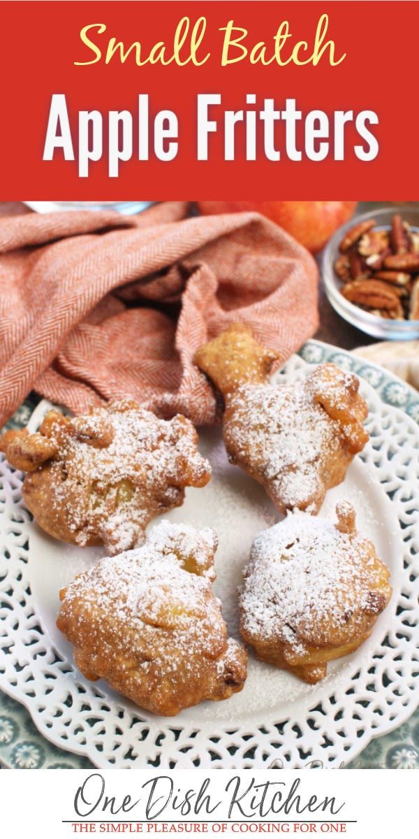 small batch apple fritters on a white plate with apples and cinnamon in the background