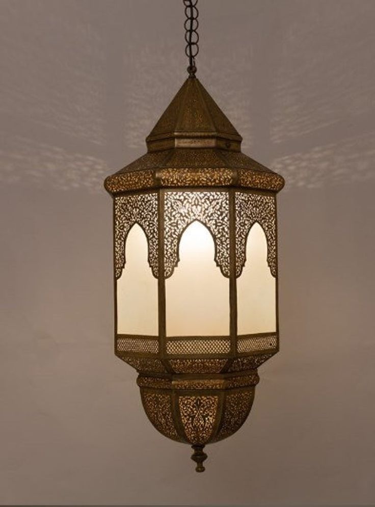 a hanging light fixture with an intricate design