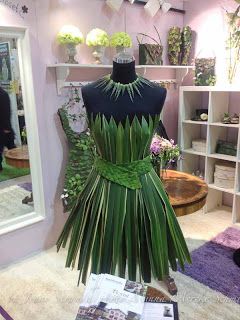 a dress made out of palm leaves on display