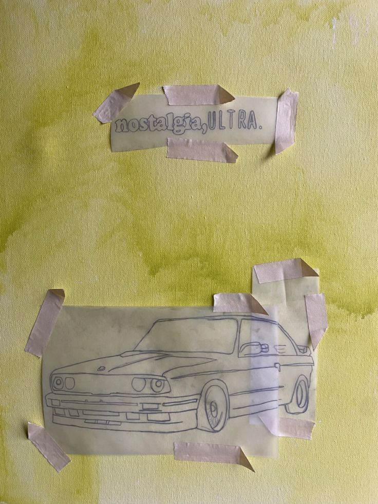 two pieces of torn paper with drawings of cars on them and one piece missing from the wall