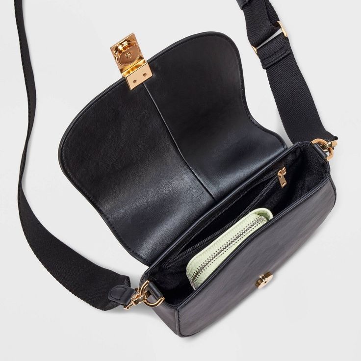 This Saddle Crossbody Bag from A New Day™ with a structured silhouette features a roomy main compartment and an interior zip pocket for easy organization of your belongings, plus an overlapping flap with a gold-tone buckle accent and magnetic closure. Plus, the detachable adjustable shoulder strap makes carrying a breeze whether you sling it over one shoulder or carry it in hand. A New Day™: Style that goes wherever you do. Versatile Saddle Bag With Gold-tone Hardware For Everyday, Versatile Saddle Bag With Gold-tone Hardware For Travel, Versatile Travel Saddle Bag With Gold-tone Hardware, Daily Use Crossbody Saddle Bag With Gold-tone Hardware, Travel Shoulder Belt Bag With Gold-tone Hardware, Travel Belt Bag With Gold-tone Hardware, Gold-tone Hardware Belt Bag For Travel, Travel Saddle Shoulder Bag With Gold-tone Hardware, Travel Saddle Bag With Gold-tone Hardware