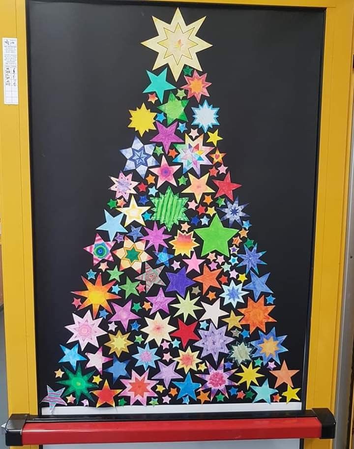 a christmas tree made out of colored stars on a blackboard with red and yellow frame