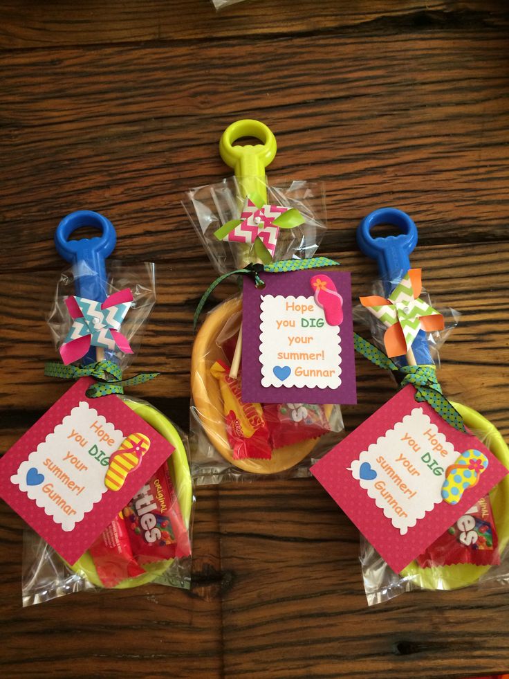 three baskets filled with candy on top of a wooden table