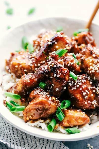 a white bowl filled with chicken and rice